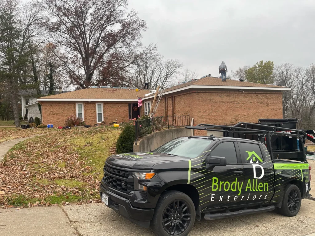 In progress image of roof replacement with Brody Allen work truck in the foreground.